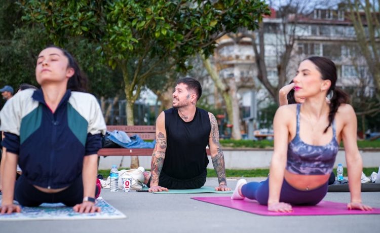 Group practicing yoga outdoors on mats in İstanbul park, embracing wellness and tranquility.